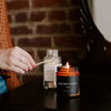 Picture of Sweet Water Decor Palo Santo Patchouli Candle | Black Pepper, Clove, Lavender, Cedarwood Scented Soy Wax Candle for Home | Gifts for Women, Men, Housewarming | 9oz Amber Glass Jar, 40 Hour Burn Time