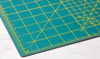 Picture of OLFA 18" x 24" Self Healing Rotary Cutting Mat (RM-SG) - Double Sided 18x24 Inch Cutting Mat with Grid for Quilting, Sewing, Fabric, & Crafts, Designed for Use with Rotary Cutters (Green)