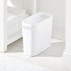 Picture of mDesign Plastic Small Trash Can, 1.5 Gallon/5.7-Liter Wastebasket, Narrow Garbage Bin with Handles for Bathroom, Laundry, Home Office - Holds Waste, Recycling, 10" High - Aura Collection, White