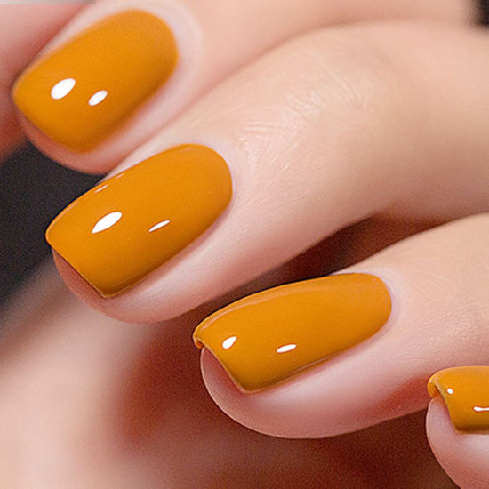 Yellow Nail Polish For Women The Handles With The Design Of The Black Twigs  On Camouflage Coating Beautiful Manicure With Matte Yellow Coating On Long Nails  Manicure Work On A Wooden Table