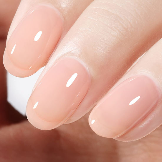 Nude manicure. Gel nail polish in light pink color. Almond shaped nails.  Beautiful manicure. Stock Photo | Adobe Stock