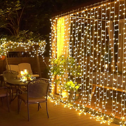 Picture of JMEXSUSS 300 LED Remote Control Christmas Curtain Lights, Plug in Fairy Curtain Lights Outdoor, Window Wall Hanging Curtain String Lights for Bedroom Backdrop Wedding Party Indoor Decor, Warm White