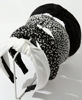 Picture of Knotted Headbands for Women: Non-Slip Fashion Hair Accessories with Cute Wide Top Knot Hoops for Hair in Black, White, and Leopard Print