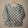Picture of mushie Long Sleeve Baby Bib | Mess Free & Waterproof Fabric for Toddlers | Adjustable Fit for Ages 6-24 Months (Olive Check)