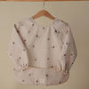 Picture of mushie Long Sleeve Baby Bib | Mess Free & Waterproof Fabric for Toddlers | Adjustable Fit for Ages 6-24 Months (Boats)