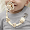 Picture of Itzy Ritzy Silicone Pacifier Clip; 100% Food Grade Silicone Pacifier Strap with Clip Keeps Pacifiers, Teethers & Small Toys in Place; Features One-Piece Design, Bear Character & Silicone Cord (Bear)